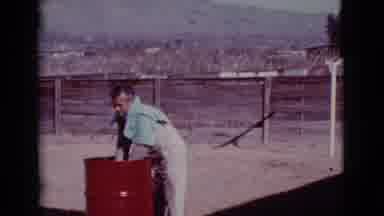 Cottonwood Arizona (1968): Man Wearing White Shirt And Pants,Rubs Black Dog With