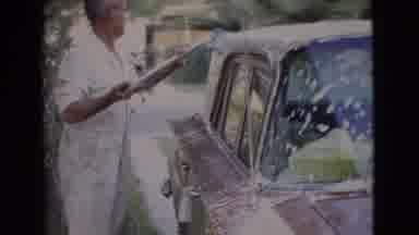 San Diego County California (1968): A Man In White Washes His Car With A Long