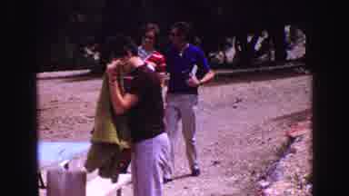 Vancouver Bc Canada (1968): Man Folding Sheet At Picnic Table While Couple Walks