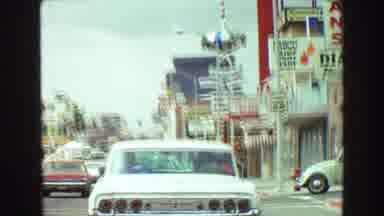 Vancouver Bc Canada (1968): A Vehicle Driving Down A Busy Street With Lots Of