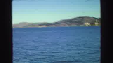Vancouver Bc Canada (1968): View Of Boat Sailing Through Bay With View Of Village
