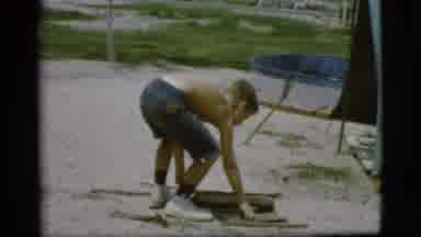 Cottonwood Arizona (1968): A Young Boy Prepares Wood For A Fire And Takes