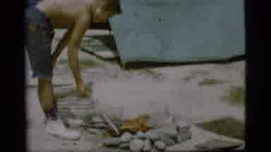 Cottonwood Arizona (1968): Shirtless Kid On A Campsite Poking A Bonfire With A