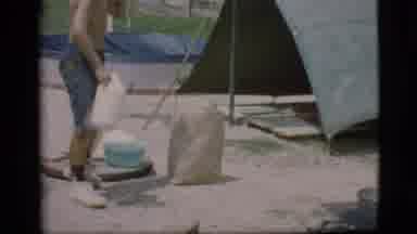 Cottonwood Arizona (1968): Child Pouring Something Into Pot On A Campfire In Front