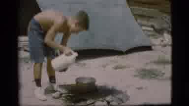 Cottonwood Arizona (1968): Boy In Shorts Near Tent Pouring Liquid From White Jug