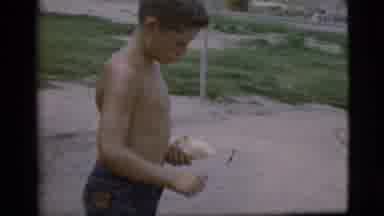 Cottonwood Arizona (1968): Shirtless Boy Peels Fruit Into A Plate With A Knife
