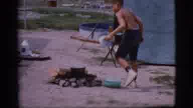 Cottonwood Arizona (1968): A Young Boy In Shirts With No Shirt Near A Campfire