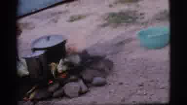 Cottonwood Arizona (1968): A Young Man Checking What He Has On His Campfire At A