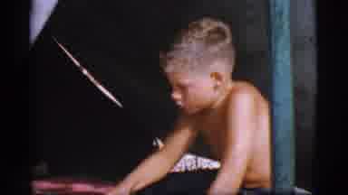 Cottonwood Arizona (1968): A Boy In Denim Shorts And No Shirt Sits In A Tent