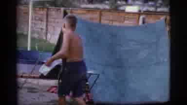 Cottonwood Arizona (1968): A Young Boy Without A Shirt Carries A Pot Into A Blue