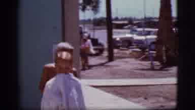 Cottonwood Arizona (1968): Boy Wrapped In Blue Towel Walks Past Camera On A Sunny