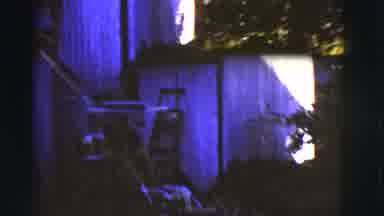 Arizona USA (1968): A German Shepherd Dog Attacks A Lawnmower As A Man Starts It