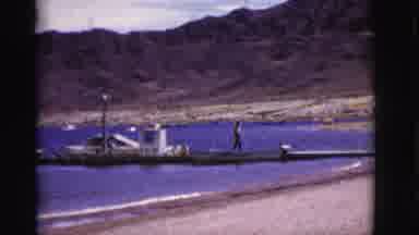 Arizona USA (1968): Person Walks Briskly Up A Dock Where Along The Beach Many