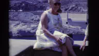 Arizona USA (1968): Man And Woman Sitting Outside Near A Rocky Formation In The