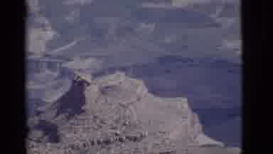Arizona USA (1968): Woman Wearing Blue Scarf Walks Past Green Trees On A Clear Day