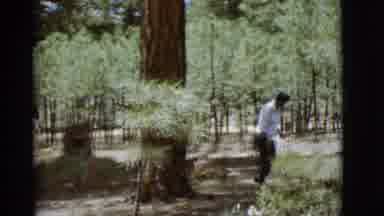 Arizona USA (1968): Person Walking Amongst Teens Bending Down To Pick Up Something