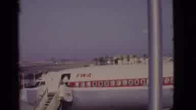 Arizona USA (1968): A Red And White Twa Airplane Sitting At An Airport Loading