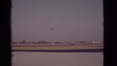 Arizona USA (1968): An Airplane Taking Off On A Runway Near A Lake