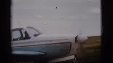 Flagstaff Arizona (1968): A Small Blue And White Propeller Plane Driving Down The