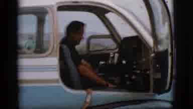Flagstaff Arizona (1968): Man Wearing Black Shirt Sits In Cockpit Of Blue And
