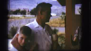 Flagstaff Arizona (1968): Man Standing With Arm Around Two Boys Pans To Shot Of