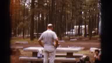 Flagstaff Arizona (1968): Family Man Builds Camp Fire On Picnic Table In Forest