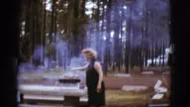 Flagstaff Arizona (1968): A Lady Standing At A Picnic Table In A Park Grilling