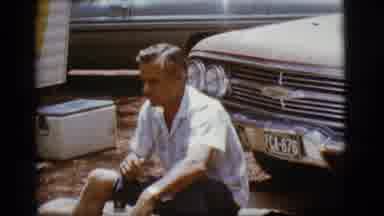 Flagstaff Arizona (1968): A Middle Aged Man Shrugs His Shoulders While Sitting In