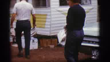Flagstaff Arizona (1968): Older Man And Woman Outside Walking Towards A White And