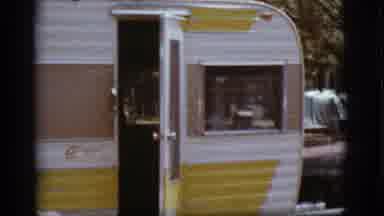 Flagstaff Arizona (1968): View Of A Camper That Is Yellow Brown And White Sitting