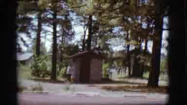Flagstaff Arizona (1968): Woman Pointing At Shed Door And Walking Away In