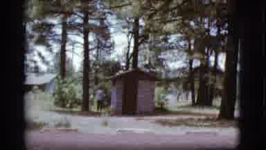 Flagstaff Arizona (1968): Person Walking Into An Outhouse In The Forest
