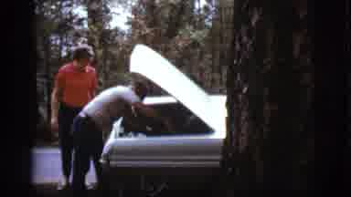 Flagstaff Arizona (1968): Man And Woman Load Up The Car And Man Brushes Off His