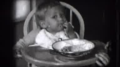 New Hampshire USA (1942): Baby Girl Eating By Herself In A Highchair With Pretty