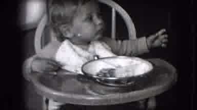 New Hampshire USA (1942): Baby Eating Dinner In A Baby Seat In Black And White