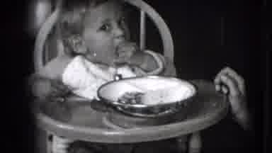 New Hampshire USA (1942): Black And White Toddler Sitting In A High Chair Eating