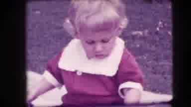 New Hampshire USA (1942): Small Kid With Blonde Hair And Red Clothes Holding An