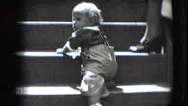 New Hampshire USA (1942): Barefoot Child Trying To Go Down Ladder On His Back
