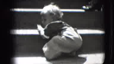 New Hampshire USA (1942): Baby Wearing Grey Overalls Crawls On Sidewalk On A Sunny