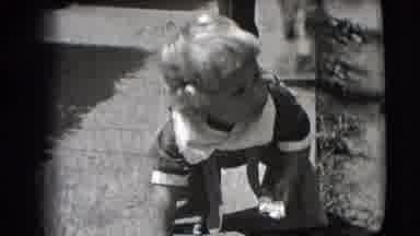 New Hampshire USA (1942): Toddler Picks Up Something Off The Ground Before
