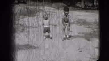 New Hampshire USA (1942): A Small Child Stands Hunched And Stares At The Camera