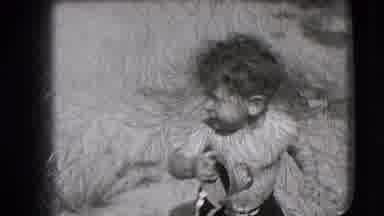New Hampshire USA (1942): A Little Boy Is Playing In The Sand Outside With Adults