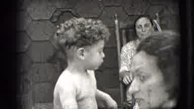 New Hampshire USA (1942): Mother Feeding Her Curly Haired Child With A Spoon