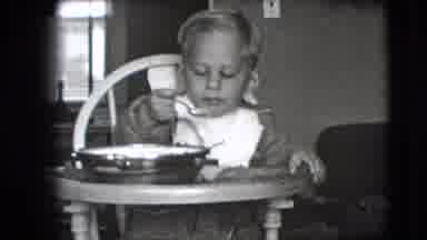 New Hampshire USA (1942): Child Eating Food From Bowl In High Chair