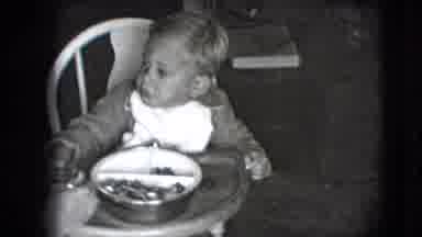 New Hampshire USA (1942): Little Child Eating While Sitting In A A High Chair