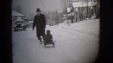 Buffalo New York (1944): Man In Winter Coat And Hat Pulls A Little Kid On A Sled