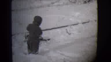 Buffalo New York (1944): Toddler Wearing Snowsuit Tries Pulling Sled On A Clear