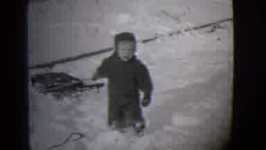 Buffalo New York (1944): Boy Tugs At Sled Stuck In The Snow As Someone Runs By The