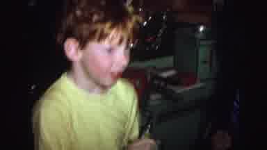 Lynbrook New York USA (1976): A Boy With Red Hair And Wearing Yellow Pajamas Sits
