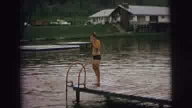Superior Wisconsin (1973): Man Wearing Blue Shorts Prepares To Jump In Water On A
